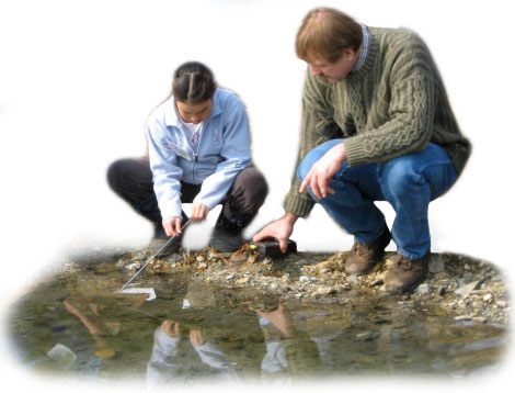 An ACMP student works with her teacher to take thermal readings at a hot spring.